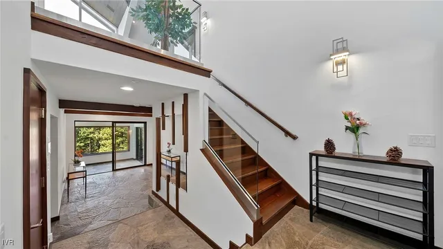 a view of entryway and hall with wooden floor