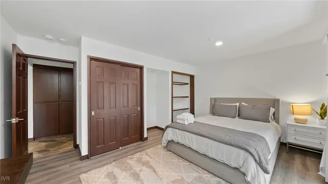 a bedroom with a bed and a closet