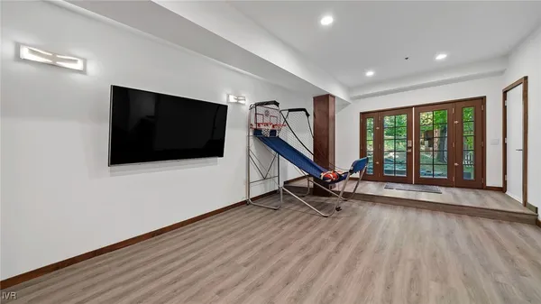 a view of a livingroom with furniture flat screen tv and floor to ceiling window