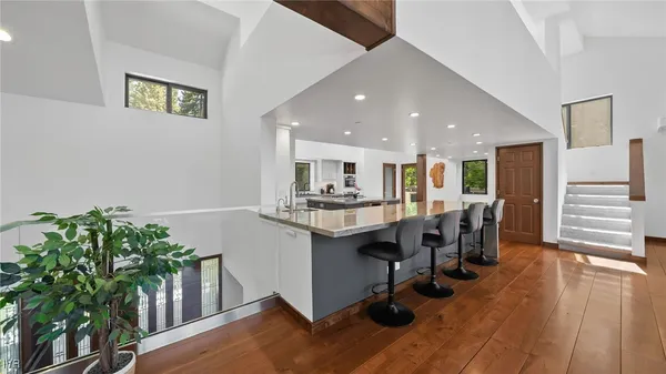 a kitchen with furniture and a potted plant