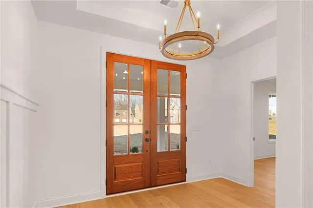 a view of empty room with wooden floor