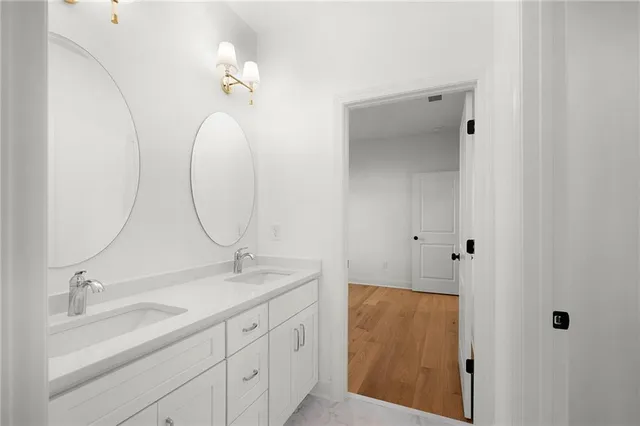 a white toilet sitting next to a bathroom sink and a shower