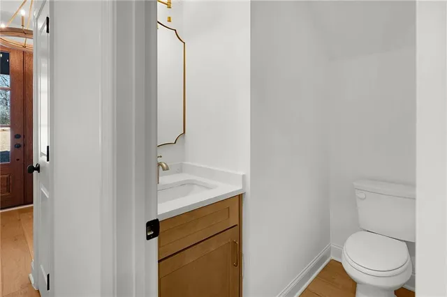 a view of empty room with wooden floor and fireplace