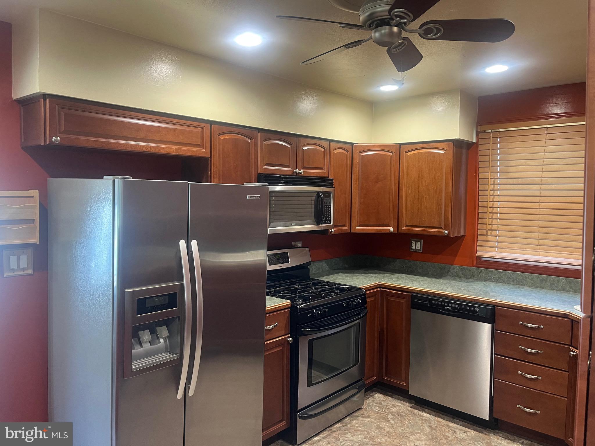 908 Homberg Avenue Baltimore, MD 21221 - Photo 20 of 31 a kitchen with stainless steel appliances granite countertop a refrigerator and a stove