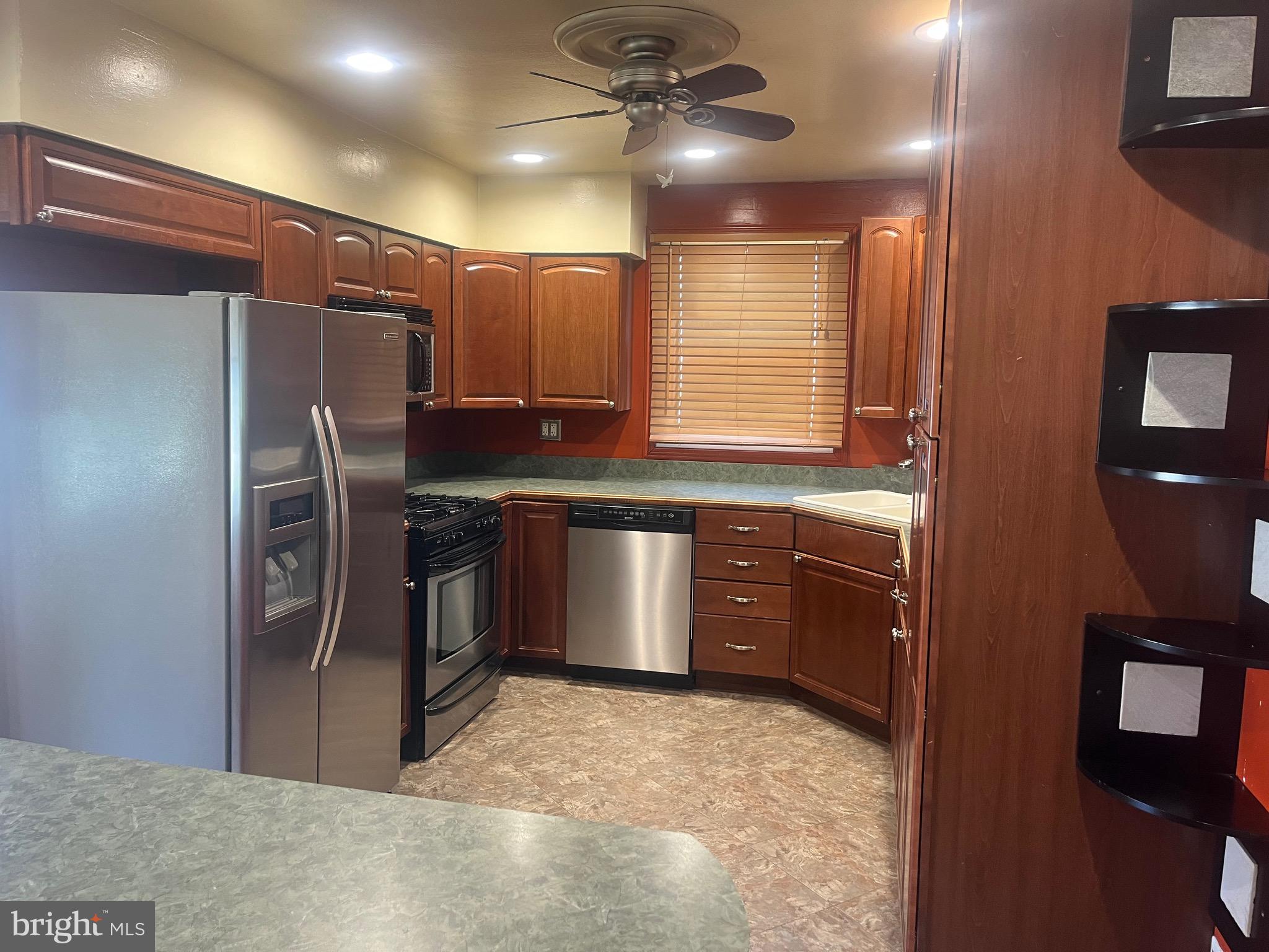 908 Homberg Avenue Baltimore, MD 21221 - Photo 22 of 31 a kitchen with stainless steel appliances granite countertop a sink stove and refrigerator