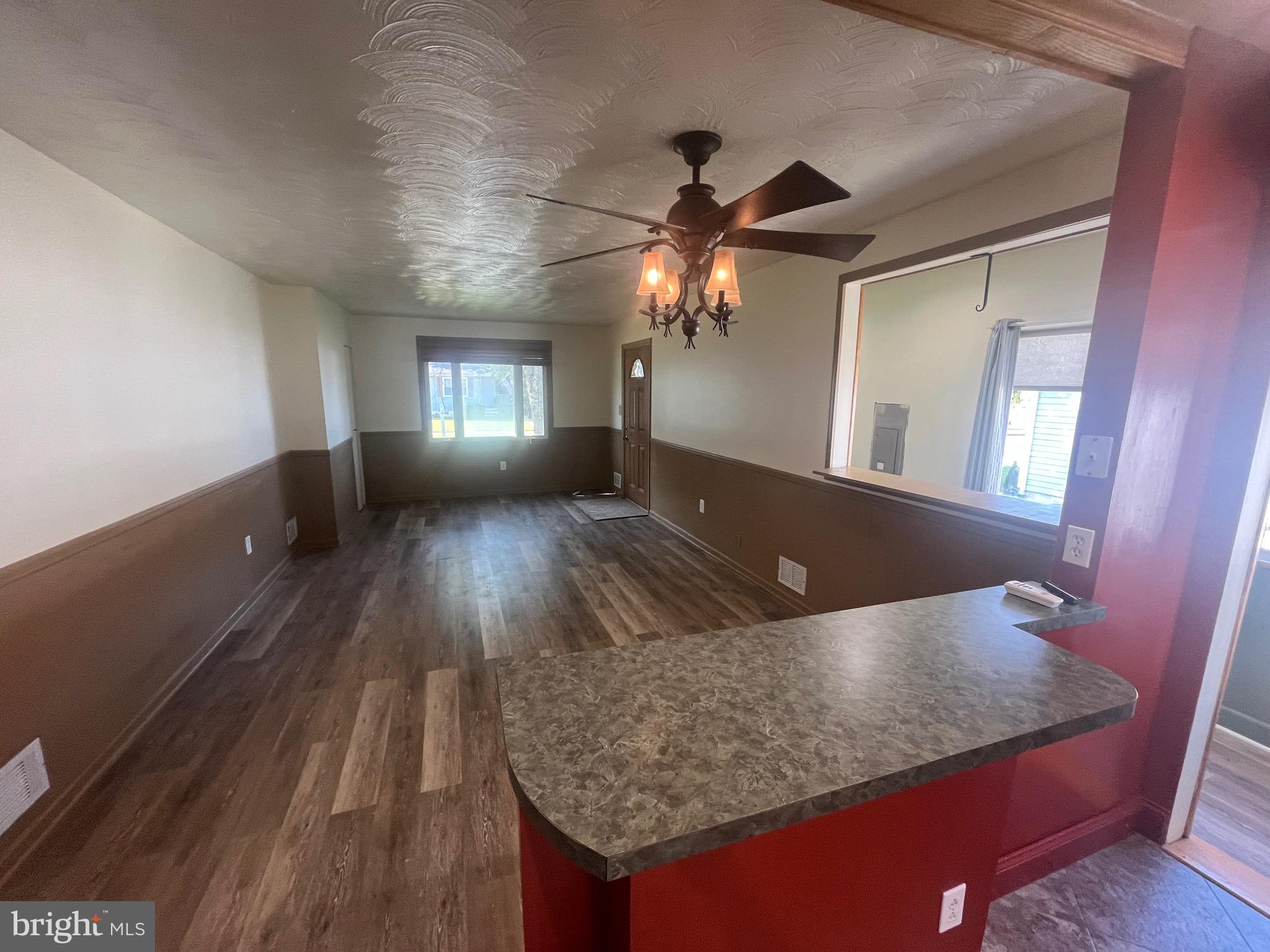 908 Homberg Avenue Baltimore, MD 21221 - Photo 26 of 31 a view of a livingroom with furniture a ceiling fan and wooden floor