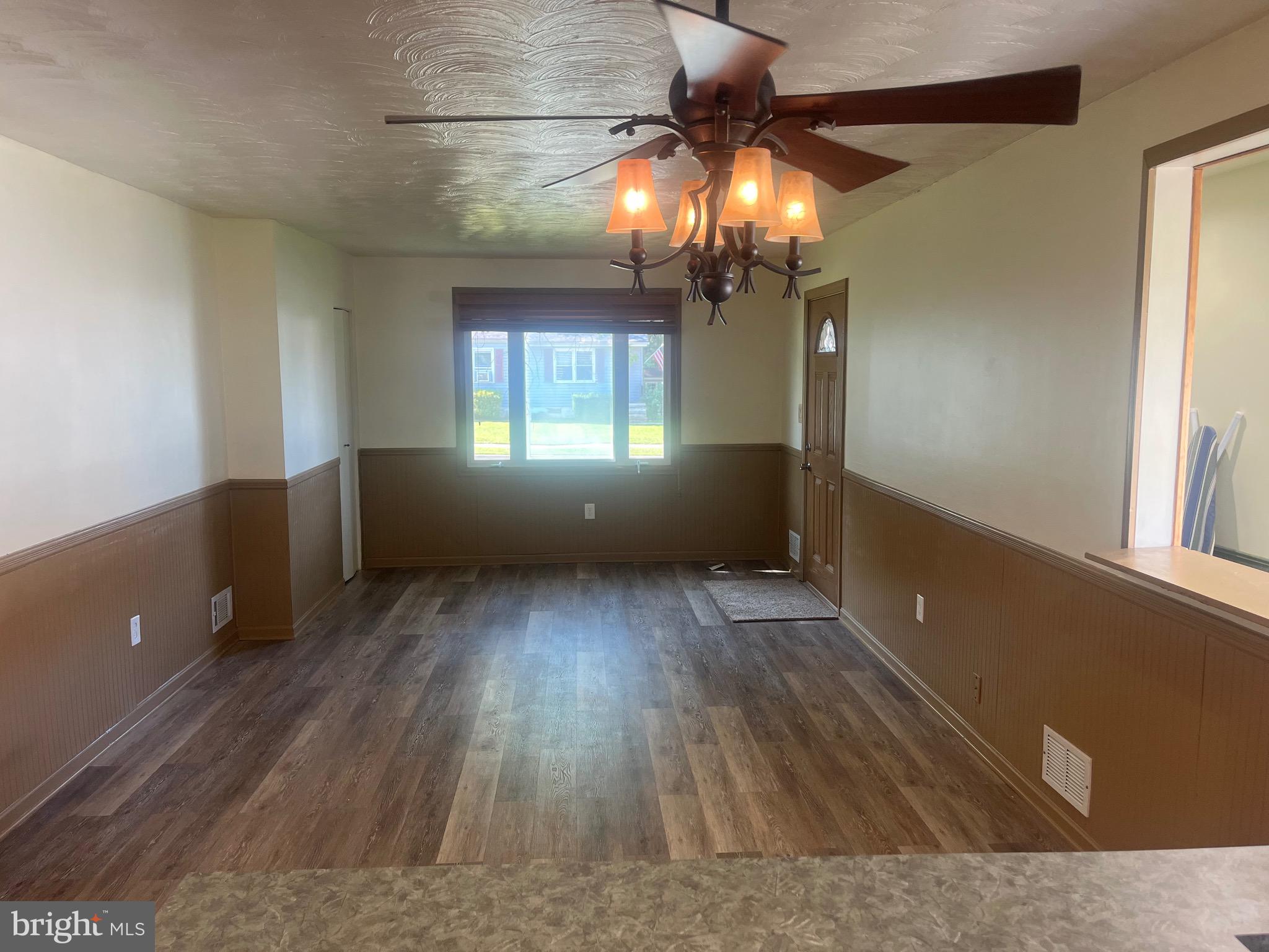 908 Homberg Avenue Baltimore, MD 21221 - Photo 30 of 31 wooden floor in an empty room with a window