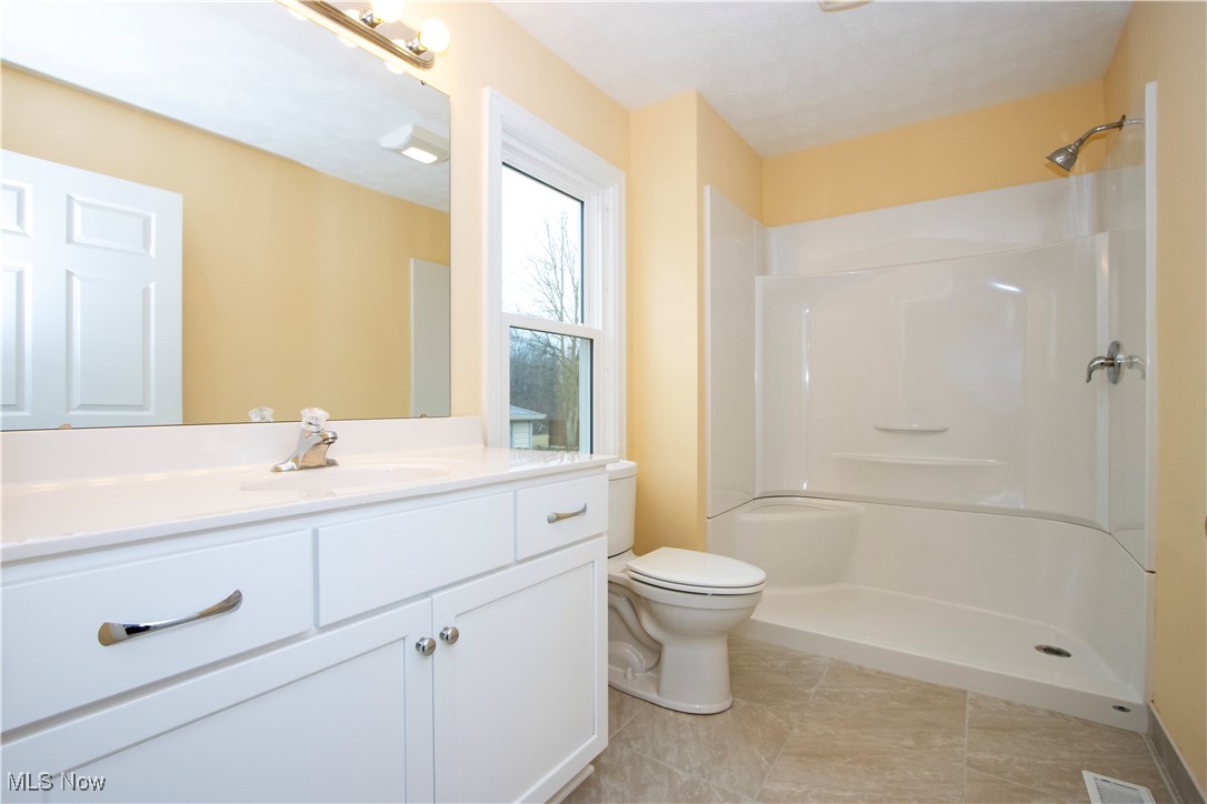 2467 Shreve Road Wooster, OH 44691 - Photo 11 of 27 Bathroom featuring toilet, visible vents, vanity, tile patterned floors, and walk in shower