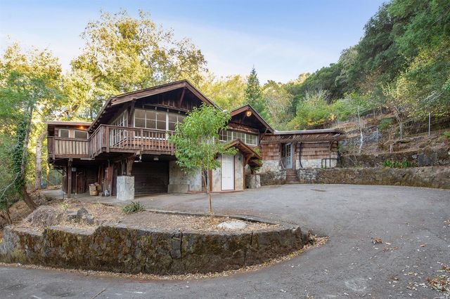 a front view of a house with a trees