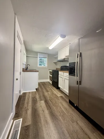 a kitchen with cabinets and stainless steel appliances