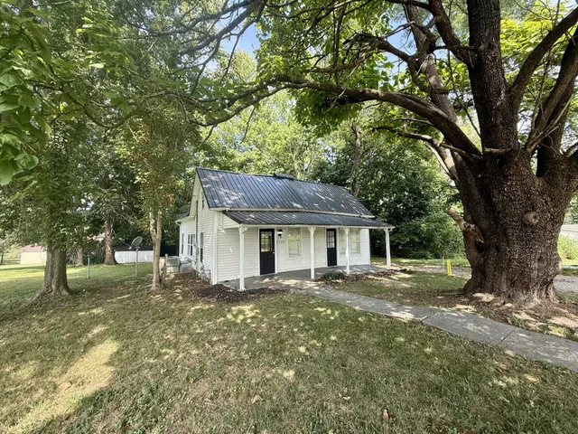 a front view of a house with a garden