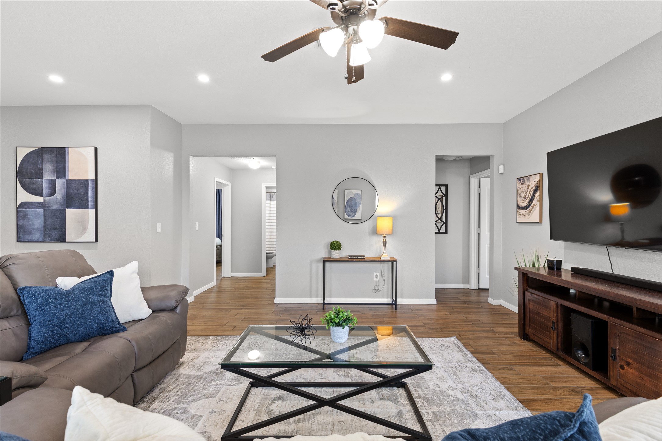 256 Alpha Kyle, TX 78640 - Photo 11 of 27 Hardwood-style tile flooring extends through this comfortable living space, featuring recessed lighting.