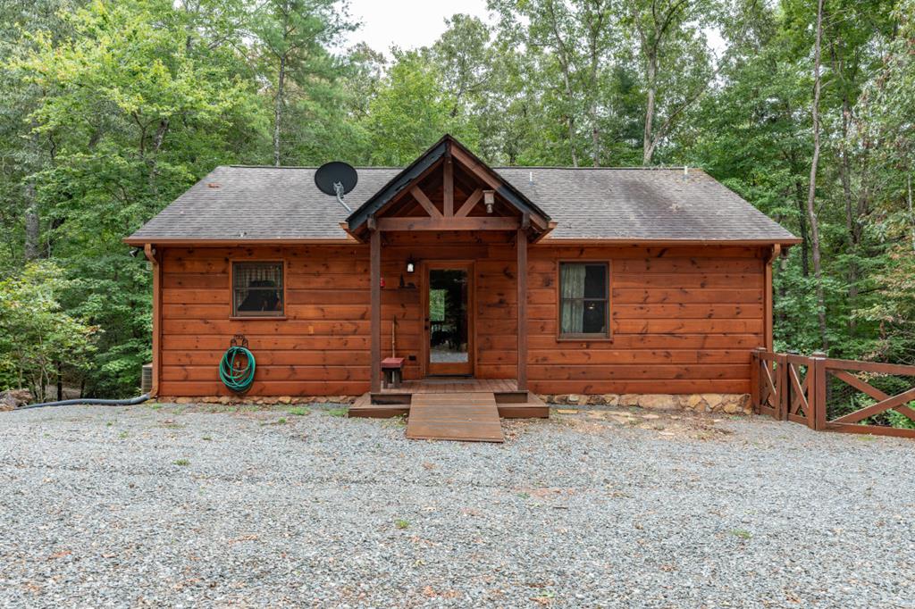 325 Pinetree Drive Blue Ridge, GA 30513 - Photo 1 of 4 a front view of a house with garden
