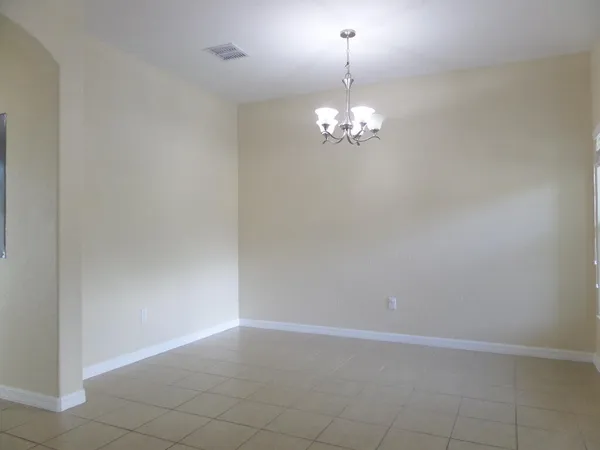 a view of a chandelier in big room and chandelier