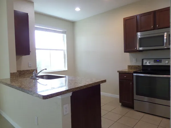 a kitchen with a stove and a microwave