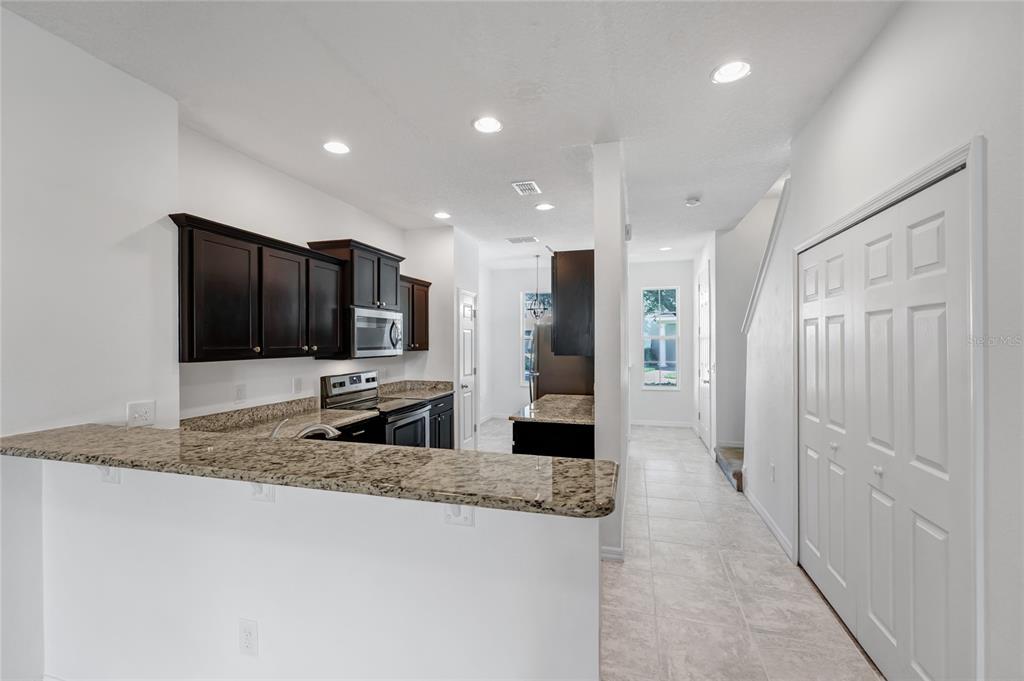 4824 Poolside Drive St. Cloud, FL 34769 - Photo 6 of 29 a kitchen with stainless steel appliances granite countertop a refrigerator and a granite counter tops