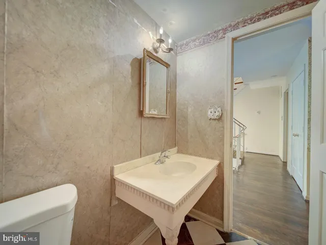 a bathroom with a sink a toilet a shower and a mirror