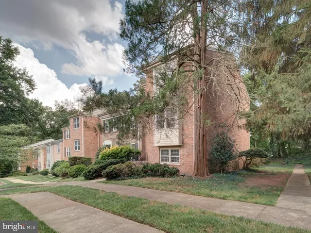 a front view of a house with a yard and a garage