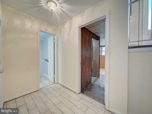 a view of a hallway to rooms