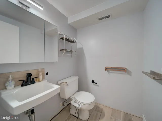 a white toilet sitting next to a bathroom sink