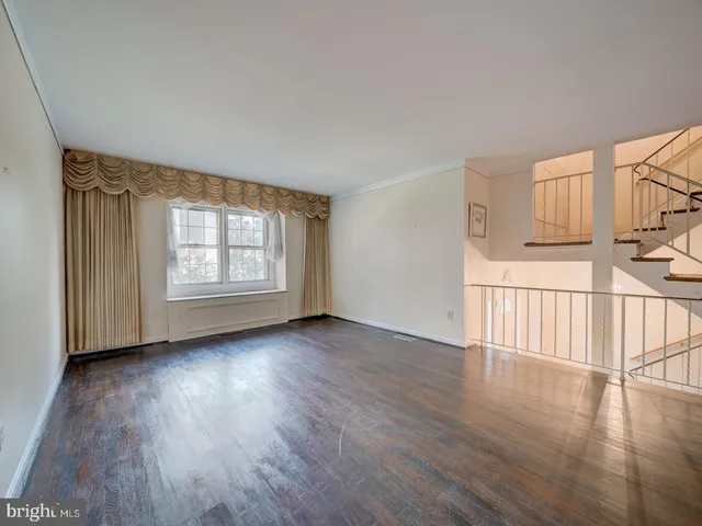 a view of a livingroom with wooden floor and a window