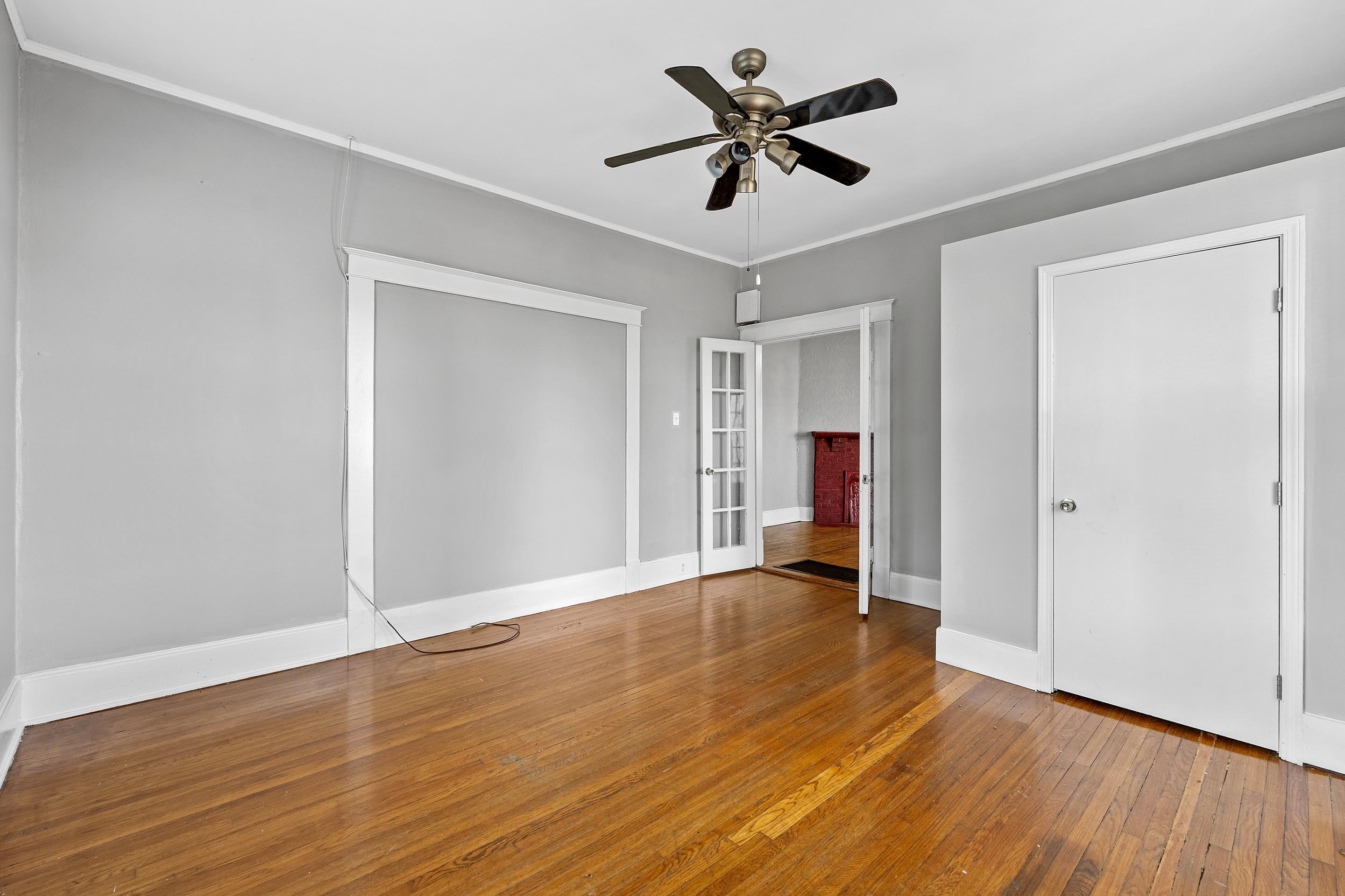 3459 Spottswood Avenue Memphis, TN 38111 - Photo 6 of 9 a view of empty room with wooden floor and ceiling fan