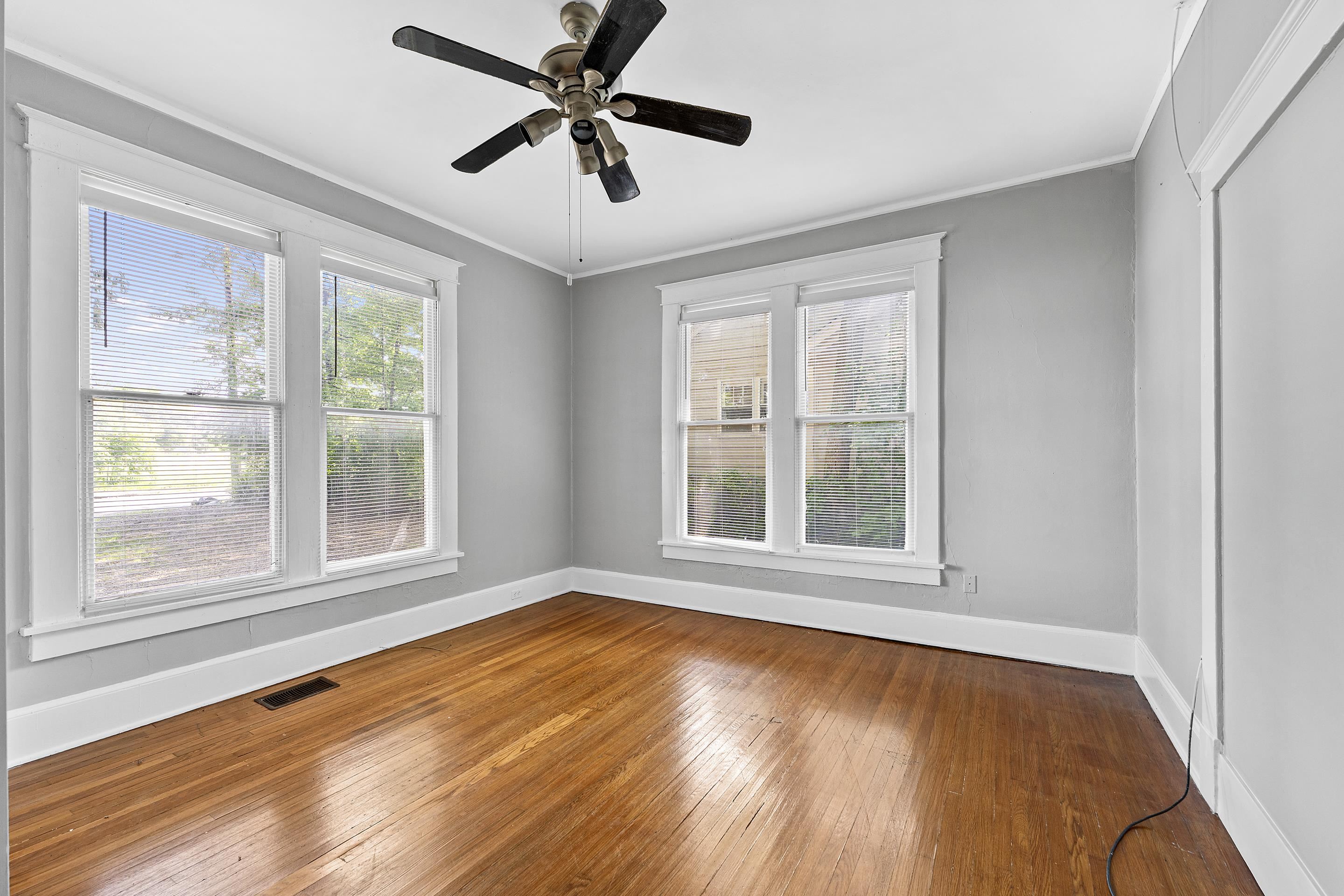 3459 Spottswood Avenue Memphis, TN 38111 - Photo 7 of 9 a view of an empty room with wooden floor and a window