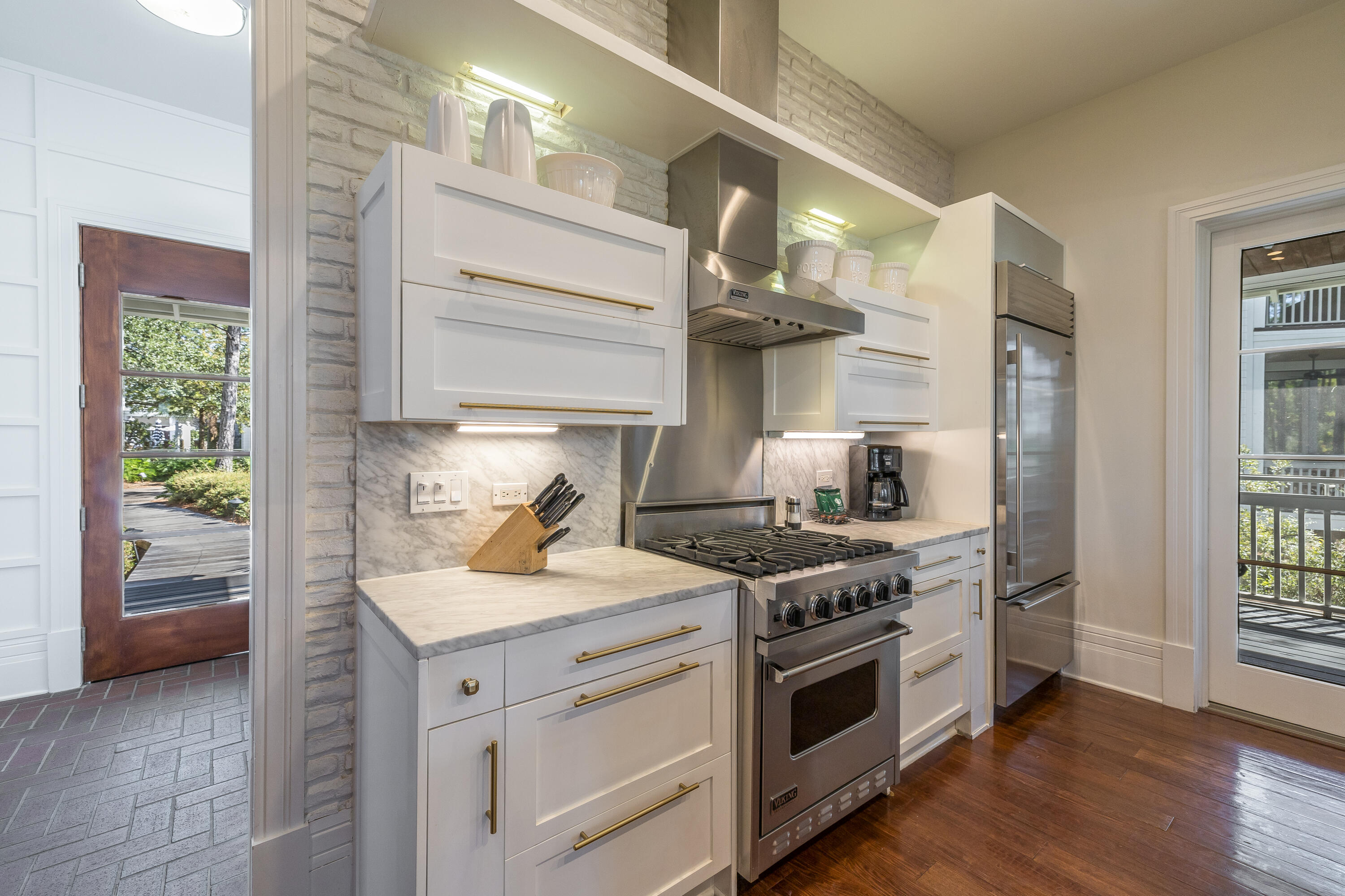8119 Inspiration Drive, Unit B2 Miramar Beach, FL 32550 - Photo 7 of 44 a kitchen with a stove and a wooden floors