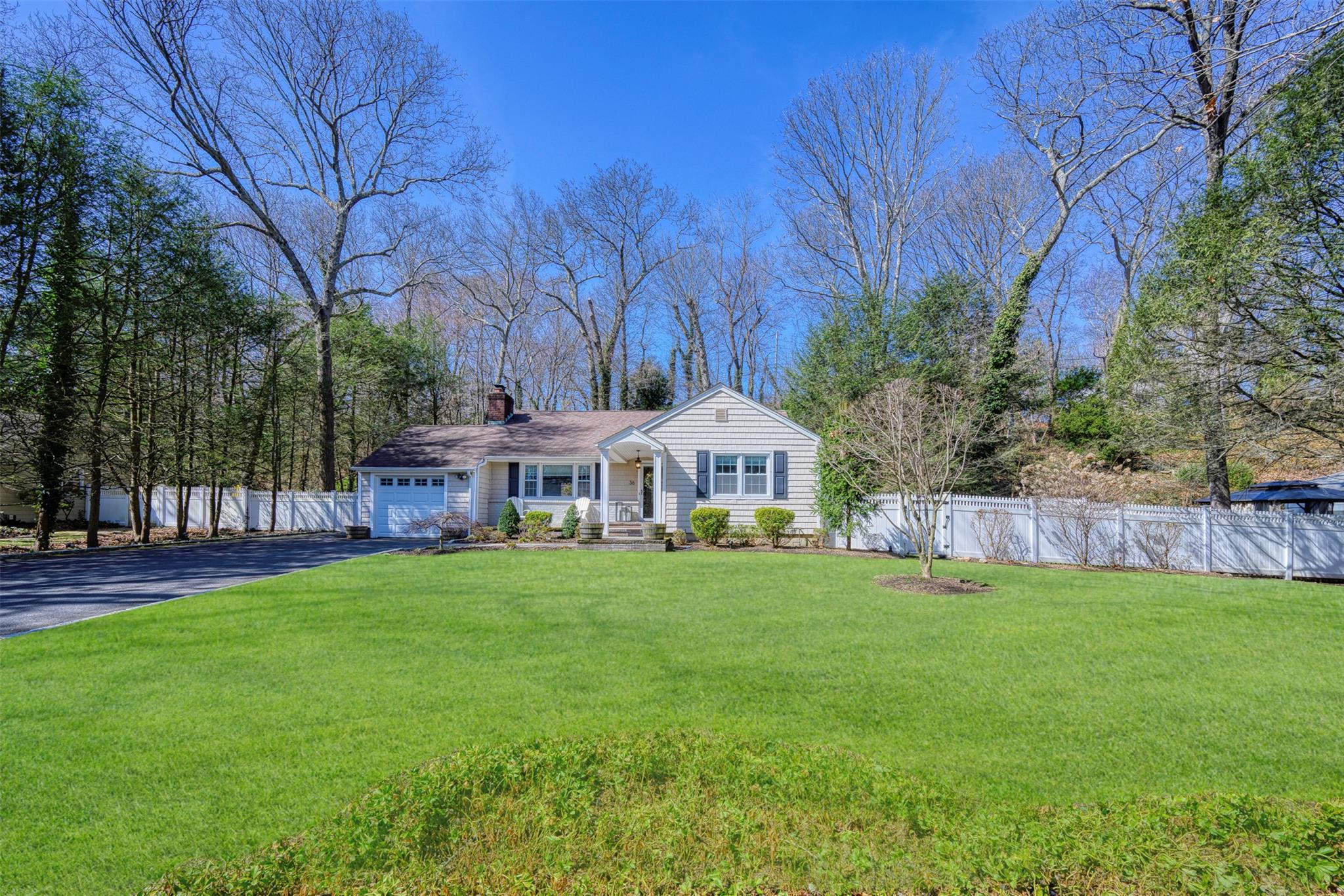 36 Cold Spring Hills Road Huntington, NY 11743 - Photo 1 of 1 View of front of property featuring fence, a chimney, a garage, a front lawn, and driveway