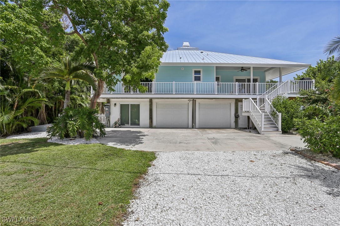 8335 Main Street Bokeelia, FL 33922 - Photo 10 of 47 front view of a house with a yard