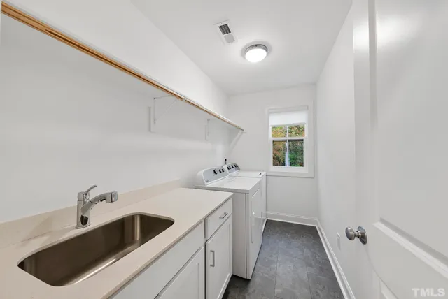 a view of a sink and dishwasher with wooden floor