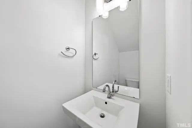 a bathroom with a sink and mirror