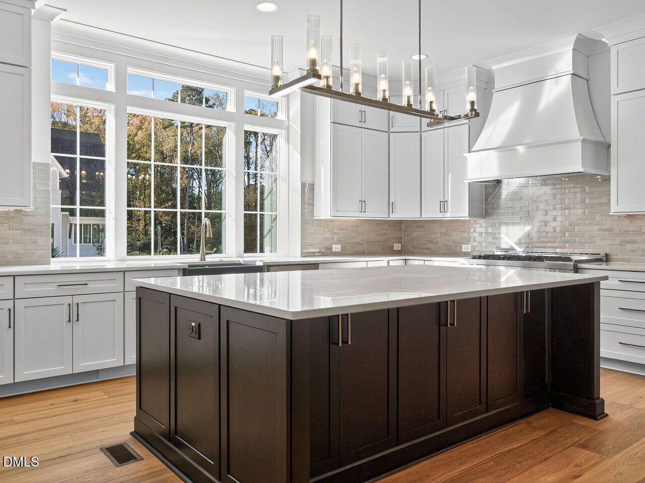 3340 Colby Chase Drive Apex, NC 27539 - Photo 18 of 59 a kitchen with stainless steel appliances granite countertop a sink a stove a refrigerator and island with wooden floor