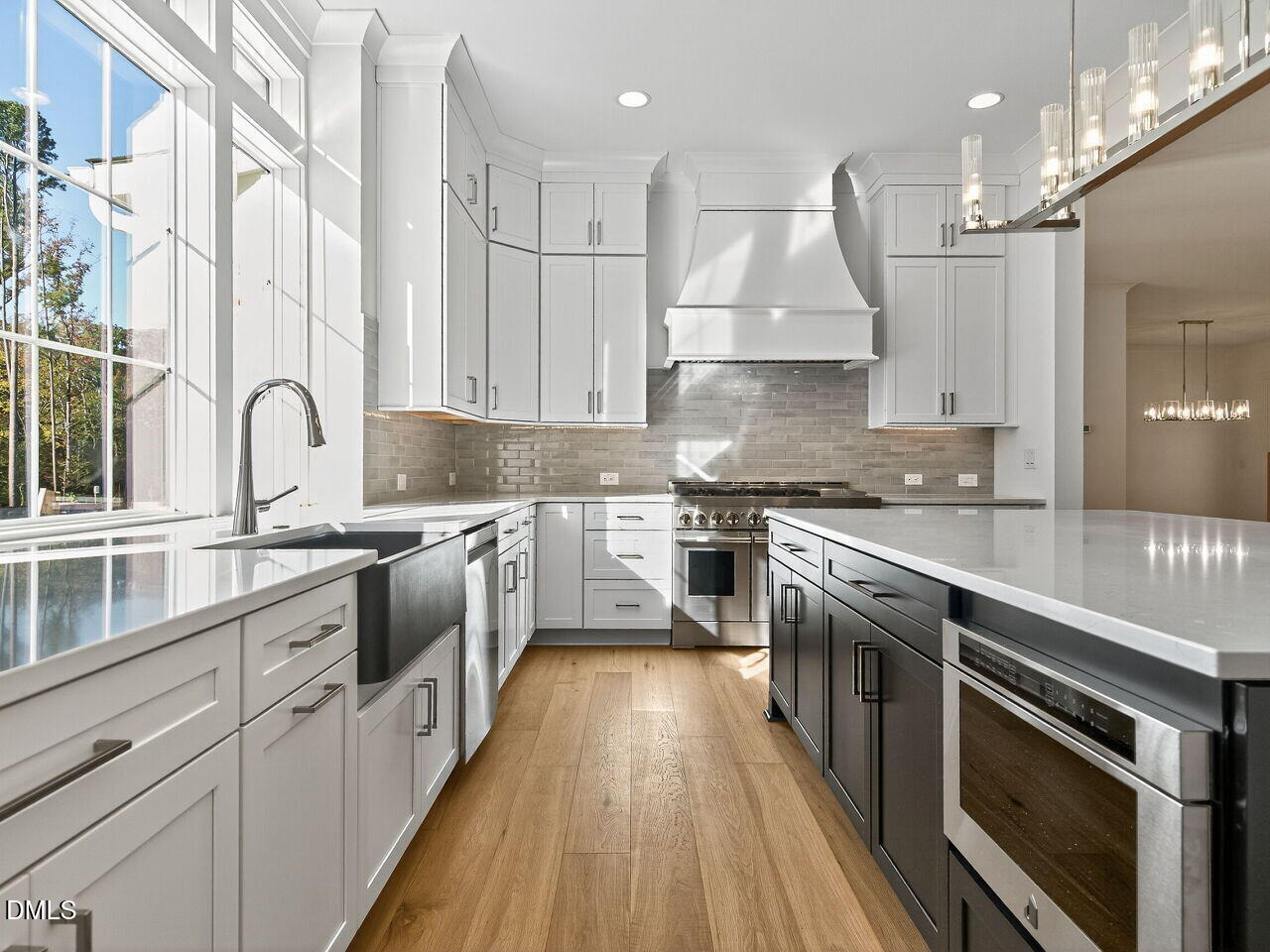 3340 Colby Chase Drive Apex, NC 27539 - Photo 19 of 59 a kitchen with stainless steel appliances granite countertop a stove top oven a sink dishwasher a refrigerator and cabinets with wooden floor