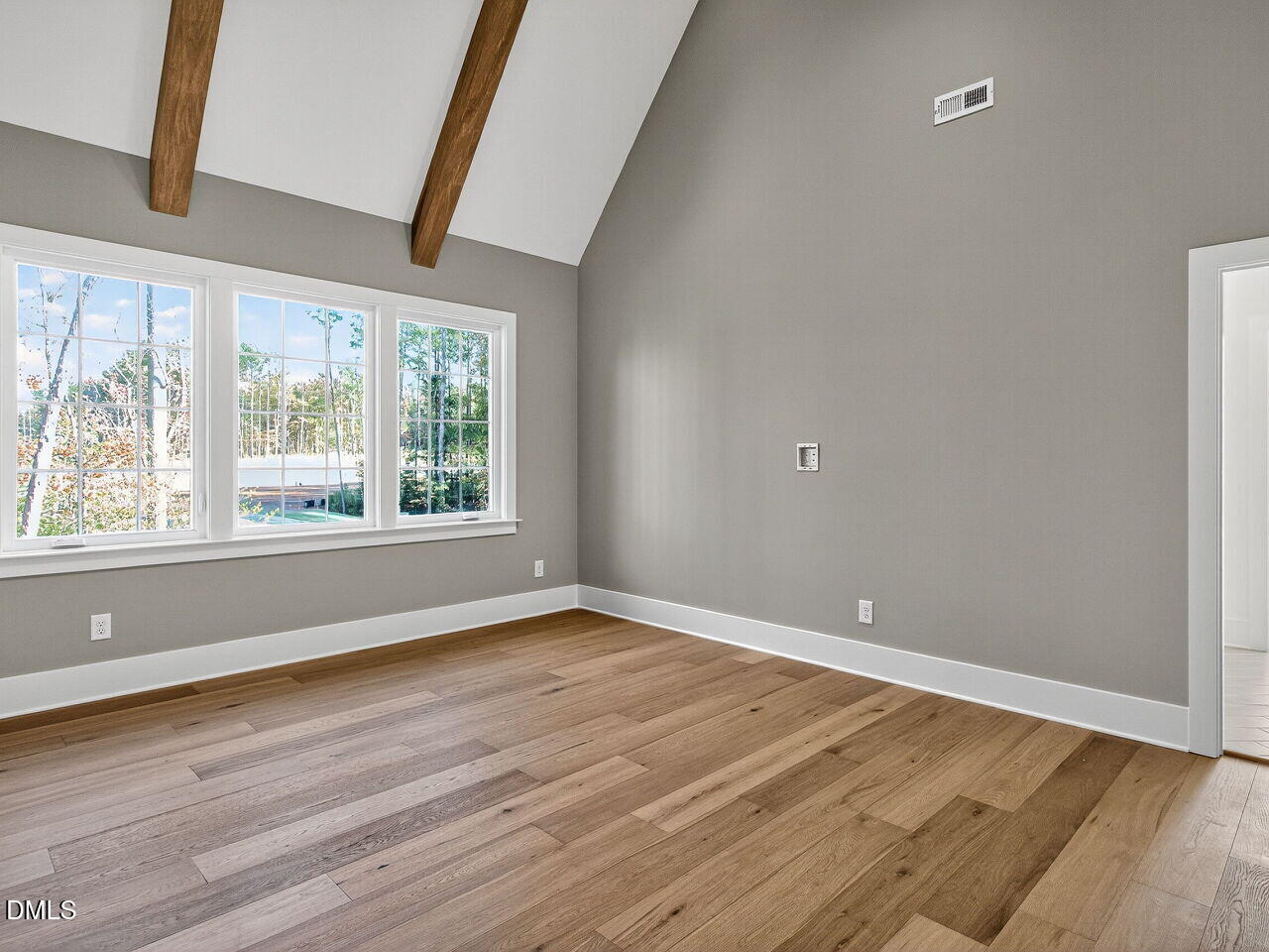 3340 Colby Chase Drive Apex, NC 27539 - Photo 35 of 59 a view of an empty room with wooden floor and a window