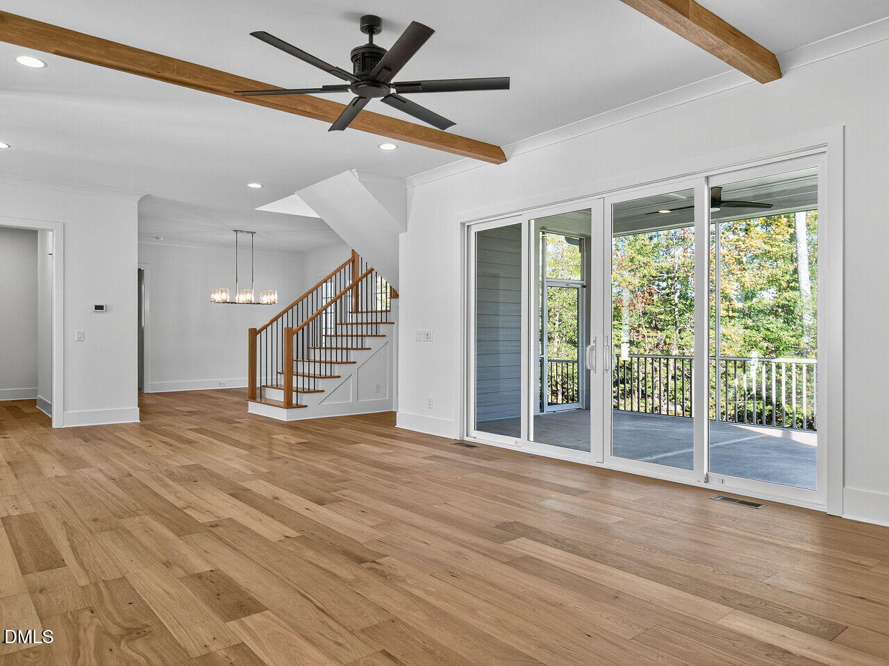 3340 Colby Chase Drive Apex, NC 27539 - Photo 10 of 59 a view of an empty room with wooden floor and a window