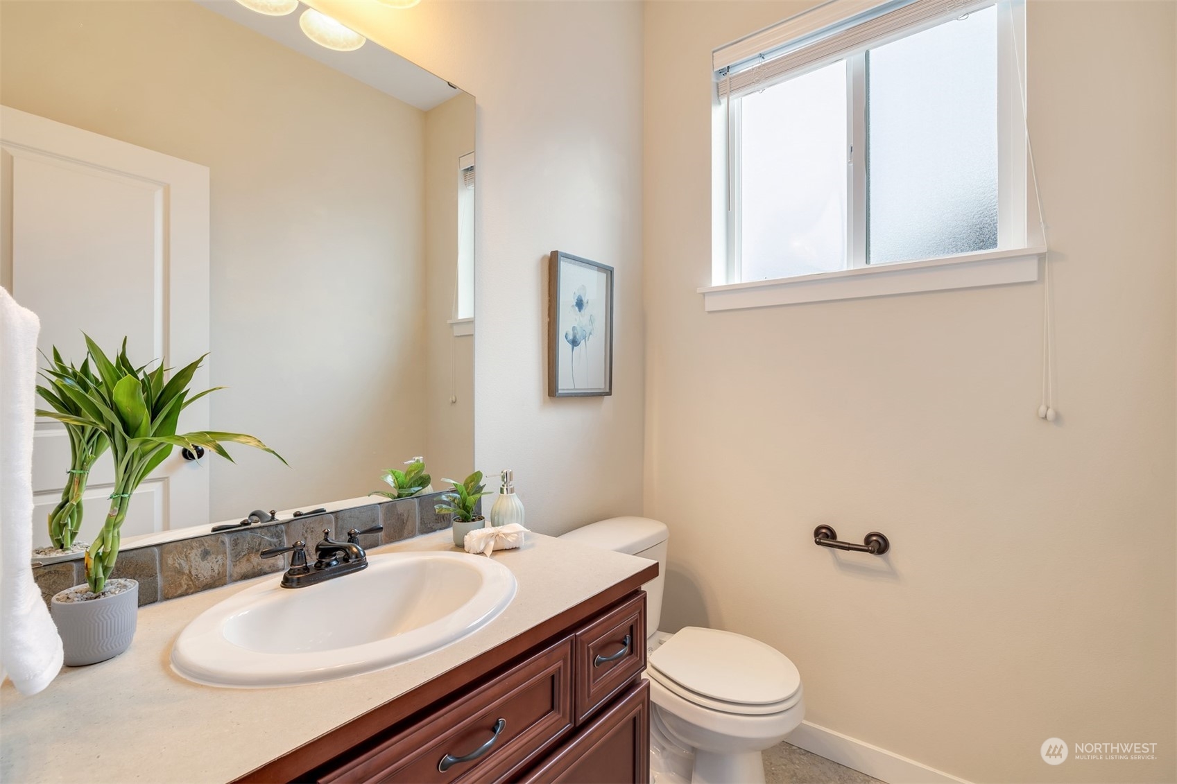 19867 Mountain Ridge Road Southeast Monroe, WA 98272 - Photo 14 of 40 a bathroom with a sink a mirror a toilet and a window