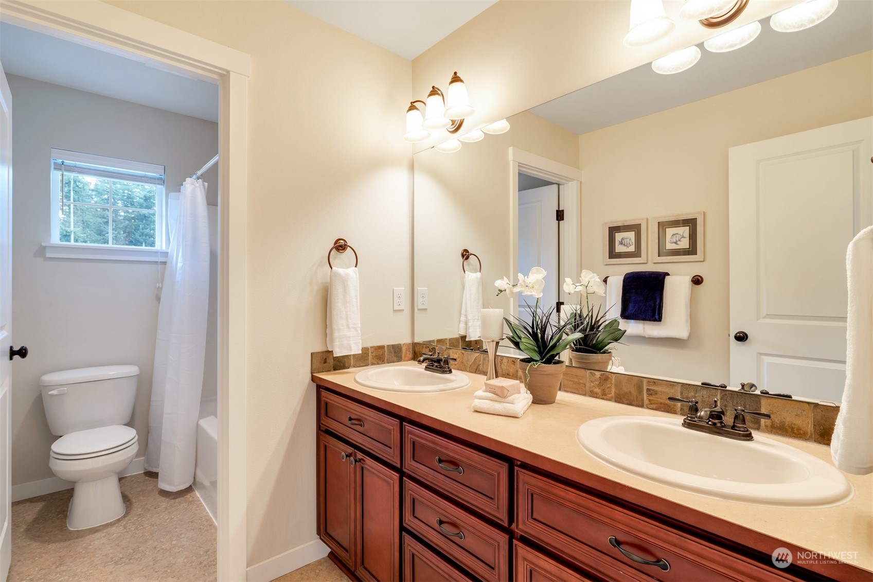 19867 Mountain Ridge Road Southeast Monroe, WA 98272 - Photo 18 of 40 a bathroom with a double vanity sink and a toilet