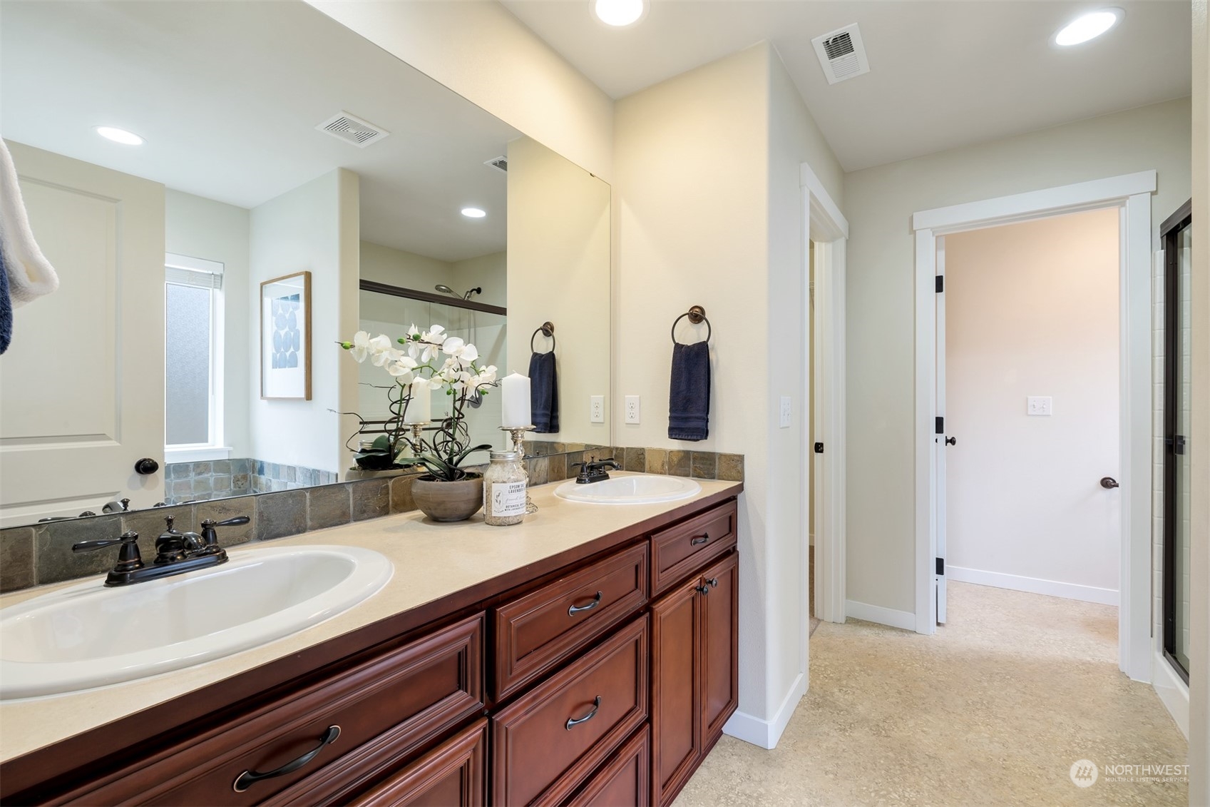 19867 Mountain Ridge Road Southeast Monroe, WA 98272 - Photo 28 of 40 a bathroom with a sink double vanity and a mirror