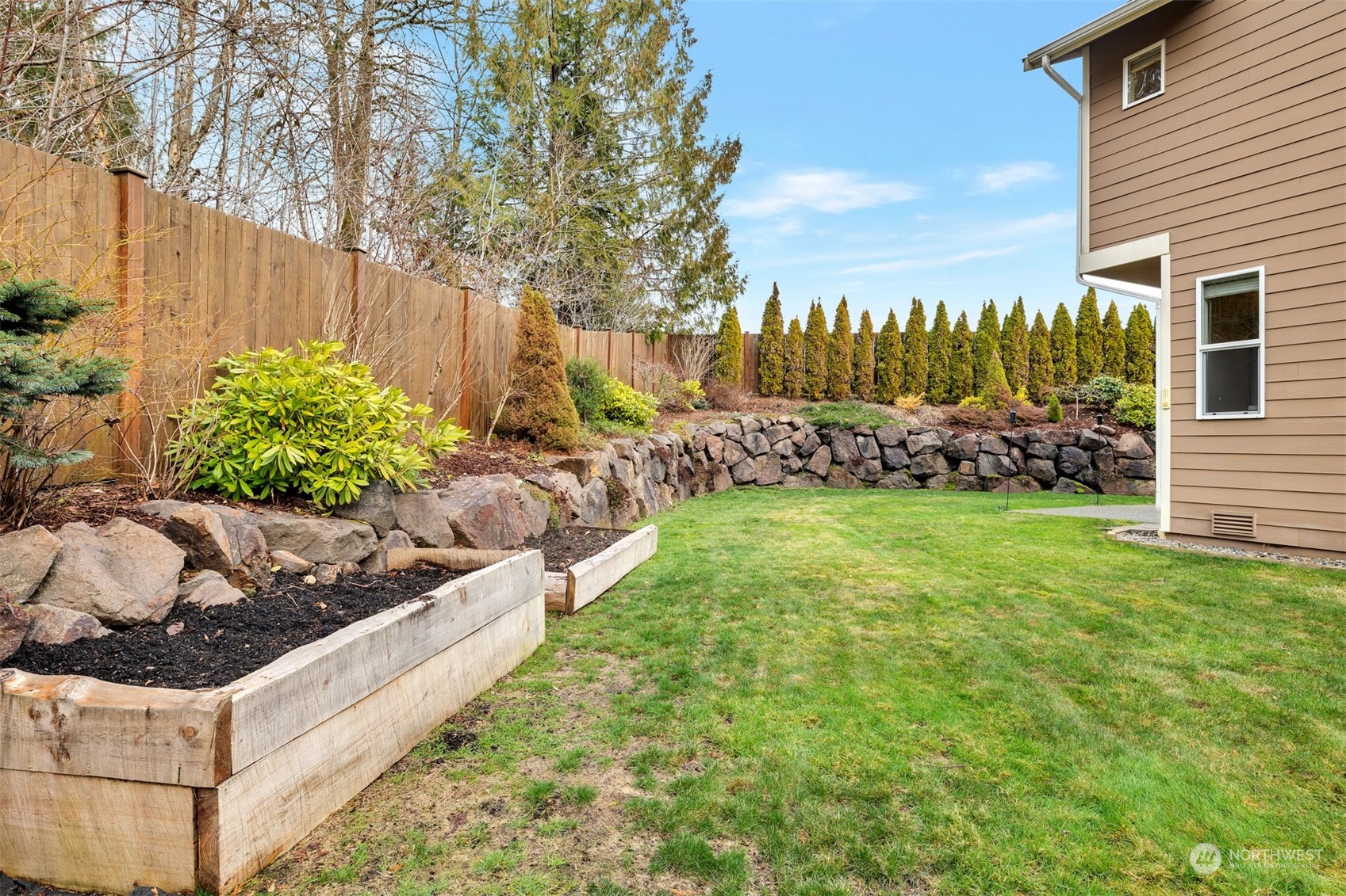 19867 Mountain Ridge Road Southeast Monroe, WA 98272 - Photo 34 of 40 a view of a garden with an outdoor seating