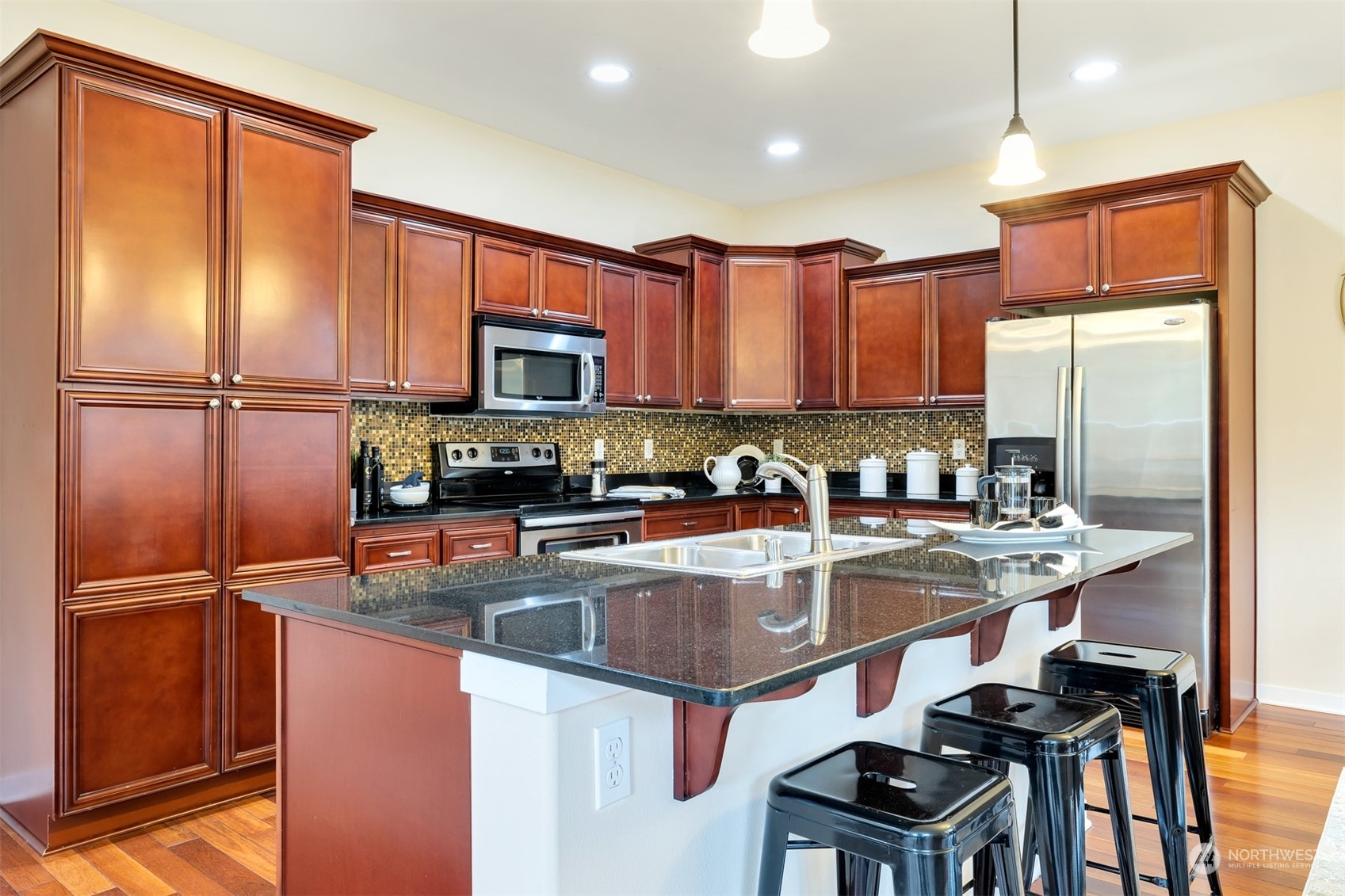 19867 Mountain Ridge Road Southeast Monroe, WA 98272 - Photo 6 of 40 a kitchen with a refrigerator a sink and cabinets