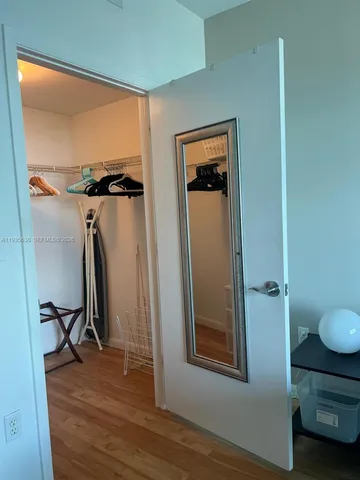 a view of workspace with wooden floor and bathroom