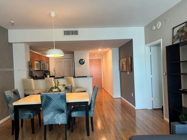 a view of a dining room with furniture and wooden floor