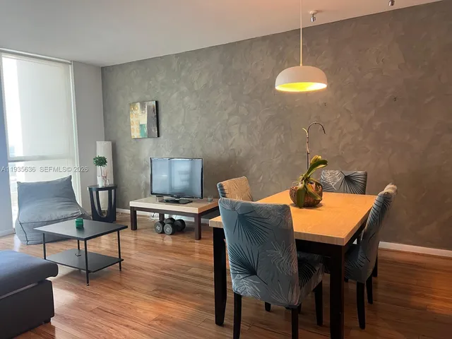 a view of a dining room with furniture and wooden floor