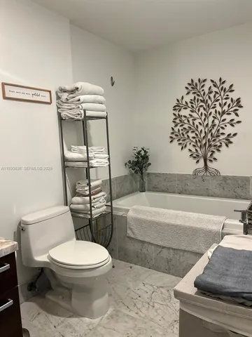 a bathroom with a toilet a sink and bathtub