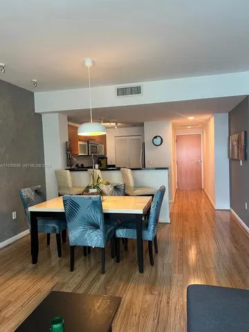a dining room with a table chairs and a wooden floor