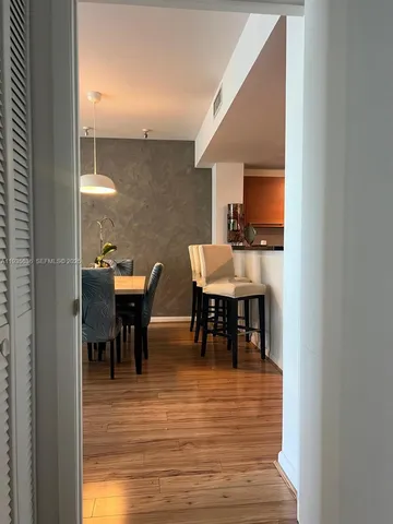 a view of a dining hall with furniture and wooden floor
