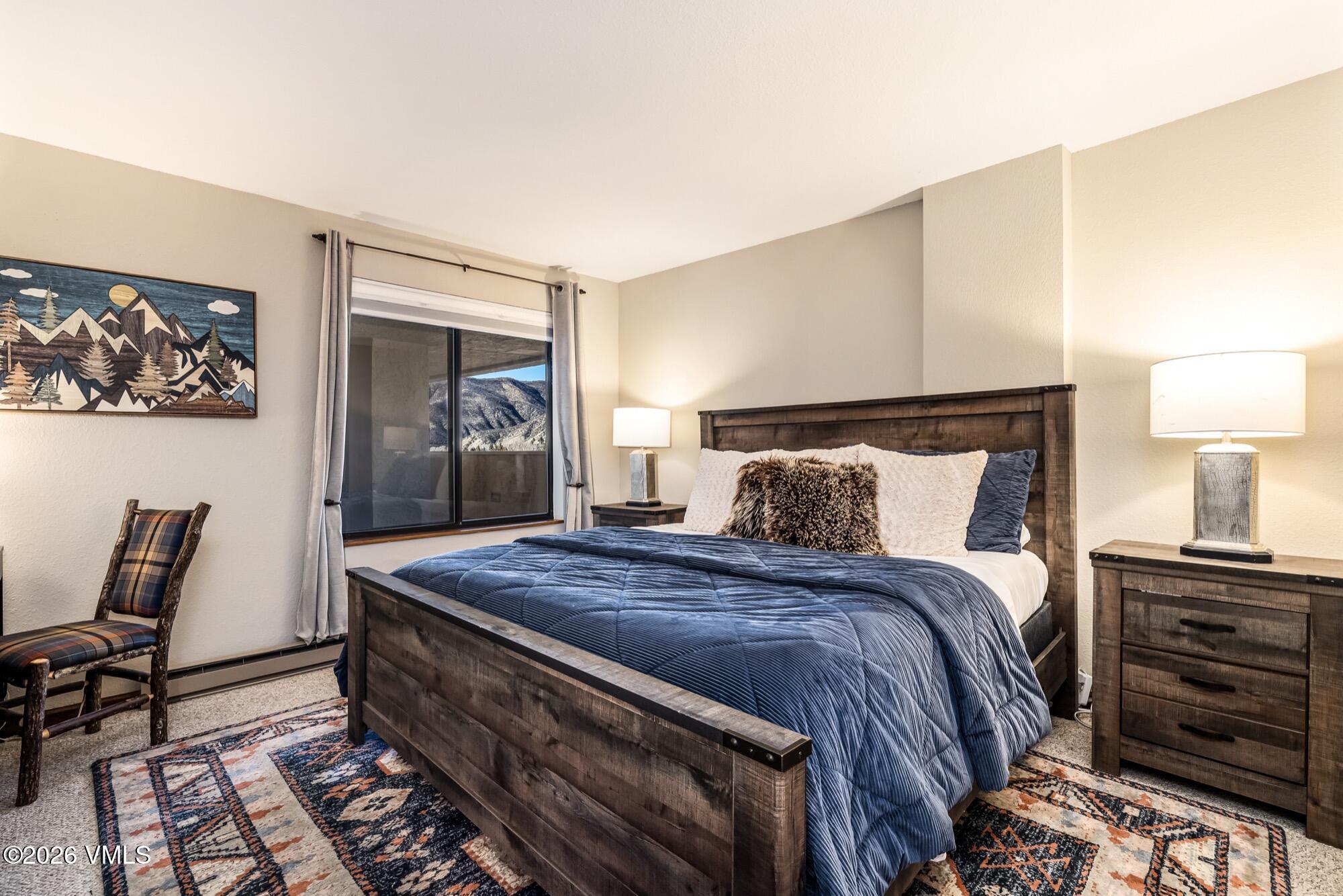 137 Benchmark Road, Unit 513 Avon, CO 81620 - Photo 22 of 31 a bed room with a bed and chair
