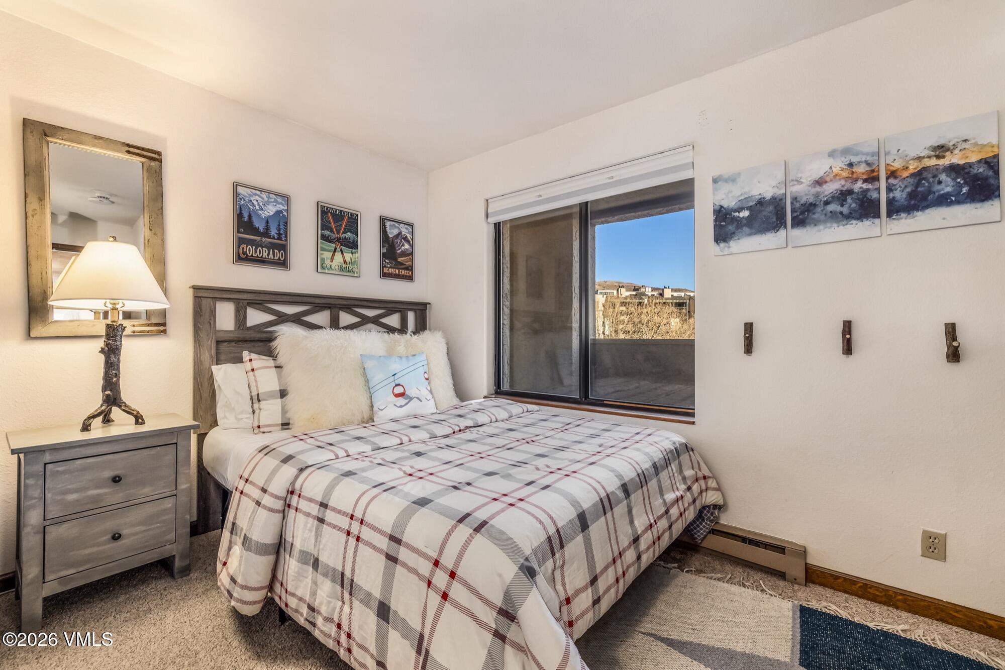 137 Benchmark Road, Unit 513 Avon, CO 81620 - Photo 25 of 31 a bedroom with a bed and a cabinets