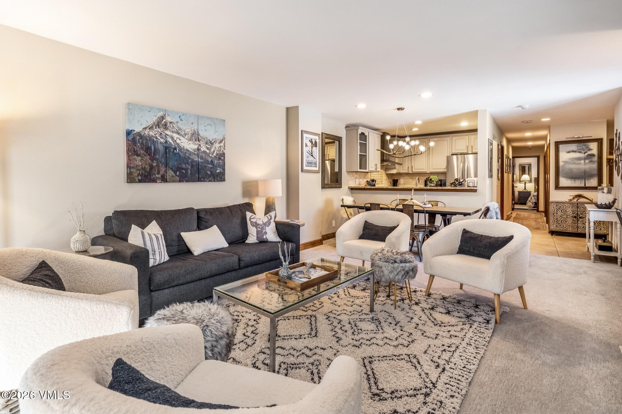 137 Benchmark Road, Unit 513 Avon, CO 81620 - Photo 6 of 31 a living room with furniture kitchen view and large windows